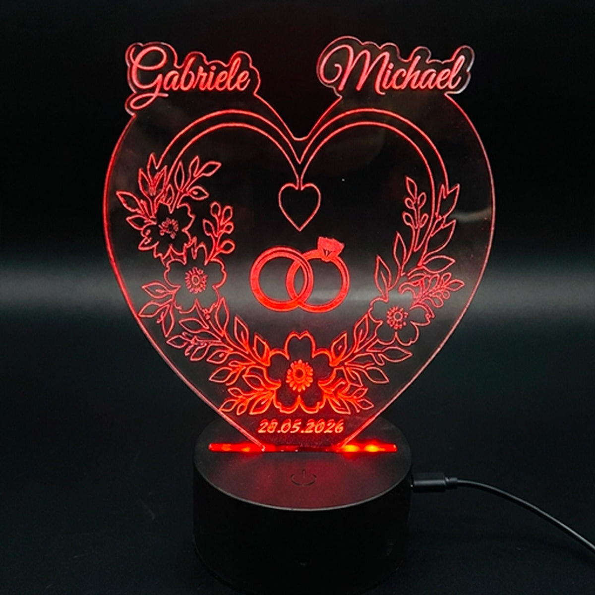 Rot leuchtende personalisierte Herzlampe mit Namen Gabriele und Michael, Blumen und Eheringen